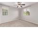 Bedroom featuring carpet flooring, ceiling fan, and two windows offering plenty of natural light at 2547 E Vermont Dr, Gilbert, AZ 85295