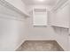 Spacious walk-in closet featuring carpet flooring, white walls and shelving for ample storage at 2547 E Vermont Dr, Gilbert, AZ 85295