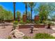 Community entrance sign with palm trees and desert landscaping creates an inviting atmosphere at 2547 E Vermont Dr, Gilbert, AZ 85295