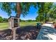 A small community library box is located next to a sidewalk and large grassy common area at 2547 E Vermont Dr, Gilbert, AZ 85295