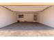 Spacious two car garage with concrete floor and a water heater in the corner at 2547 E Vermont Dr, Gilbert, AZ 85295