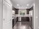 Well-equipped kitchen with stainless steel appliances, dark wood cabinets, and a window overlooking the backyard at 2547 E Vermont Dr, Gilbert, AZ 85295