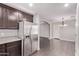 Modern kitchen with stainless steel appliances, dark wood cabinets, and an open layout leading to the living area at 2547 E Vermont Dr, Gilbert, AZ 85295