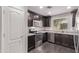 Well-equipped kitchen with stainless steel appliances, dark wood cabinets, and a window overlooking the backyard at 2547 E Vermont Dr, Gilbert, AZ 85295