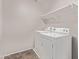 Laundry room featuring white washer and dryer, shelving, and tile flooring at 2547 E Vermont Dr, Gilbert, AZ 85295