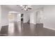 Spacious open-concept living area with dark wood floors, arches, and views of the kitchen and staircase at 2547 E Vermont Dr, Gilbert, AZ 85295