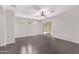Bright and airy living room featuring dark wood floors, a ceiling fan, and sliding glass doors to the backyard at 2547 E Vermont Dr, Gilbert, AZ 85295