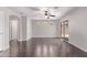 Bright and airy living room featuring dark wood floors, a ceiling fan, and sliding glass doors to the backyard at 2547 E Vermont Dr, Gilbert, AZ 85295