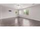 Large living room with wood floors, ceiling fan, and large windows offering plenty of natural light at 2547 E Vermont Dr, Gilbert, AZ 85295