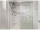 Shower with glass door, shower head, and tiled walls at 2547 E Vermont Dr, Gilbert, AZ 85295