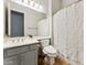 Cozy bathroom showcasing vanity, toilet, and shower with white curtain at 2830 S Riata Ct, Gilbert, AZ 85295