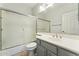 Bathroom with a sliding glass shower door, vanity sink, and ample lighting at 2830 S Riata Ct, Gilbert, AZ 85295
