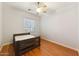 Simple bedroom with hardwood floors, a ceiling fan, and a wooden bed frame at 2830 S Riata Ct, Gilbert, AZ 85295