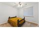 Cozy bedroom features a bed with a bright yellow coverlet and a sunny window at 2830 S Riata Ct, Gilbert, AZ 85295