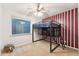 Bedroom boasting a loft bed, red striped accent wall, and a bright window at 2830 S Riata Ct, Gilbert, AZ 85295