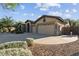 Spacious three-car garage with an extended driveway and desert landscaping at 2830 S Riata Ct, Gilbert, AZ 85295
