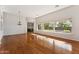 Bright living room with hardwood floors, large windows, and an elegant chandelier at 2830 S Riata Ct, Gilbert, AZ 85295