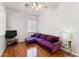 Relaxing living room features a plush purple couch and hardwood floors at 2830 S Riata Ct, Gilbert, AZ 85295