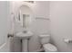 Powder room featuring a pedestal sink and toilet at 336 N 168Th Dr, Goodyear, AZ 85338