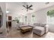 Bright living room with arched windows, a ceiling fan, and tile flooring throughout at 336 N 168Th Dr, Goodyear, AZ 85338