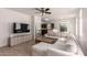 Bright and open living room with tile floors, large windows, ceiling fan, and modern furnishings at 336 N 168Th Dr, Goodyear, AZ 85338