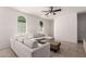 Open concept living room with tile floors, a ceiling fan, and lots of natural light at 336 N 168Th Dr, Goodyear, AZ 85338