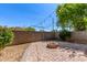 Paver patio featuring a brick fire pit, surrounded by block wall and accented with string lights at 336 N 168Th Dr, Goodyear, AZ 85338