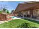 Backyard with turf and built in pool with rock waterfall feature and patio at 3480 E Cullumber Ct, Gilbert, AZ 85234