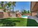 Backyard with turf and built in pool with rock waterfall feature at 3480 E Cullumber Ct, Gilbert, AZ 85234