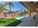 Backyard with turf and built in pool with rock waterfall feature at 3480 E Cullumber Ct, Gilbert, AZ 85234