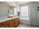 Well-lit primary bathroom features double sinks, a separate shower, and a luxurious soaking tub at 3480 E Cullumber Ct, Gilbert, AZ 85234