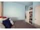 Bedroom with built-in storage, blue walls, and carpet flooring at 3480 E Cullumber Ct, Gilbert, AZ 85234