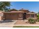 Charming single-story home with a two-car garage and desert landscaping featuring vibrant pink flowering bushes at 3480 E Cullumber Ct, Gilbert, AZ 85234