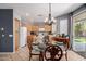 Eat-in kitchen featuring wood cabinets, a glass-top table, and sliding glass doors to the outdoor living space at 3480 E Cullumber Ct, Gilbert, AZ 85234