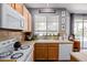 Well-equipped kitchen featuring wood cabinets, tile countertops, and modern appliances, ready for culinary adventures at 3480 E Cullumber Ct, Gilbert, AZ 85234
