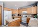 Spacious kitchen with wood cabinets, an island, and modern appliances, perfect for cooking and entertaining at 3480 E Cullumber Ct, Gilbert, AZ 85234