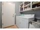 Laundry room with door, modern washer and dryer, and ample storage at 3480 E Cullumber Ct, Gilbert, AZ 85234