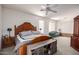 Spacious primary bedroom boasts ample natural light, a ceiling fan, and a cozy sitting area at 3480 E Cullumber Ct, Gilbert, AZ 85234