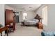 Comfortable primary bedroom with carpet floors, abundant natural light, and an ensuite bathroom at 3480 E Cullumber Ct, Gilbert, AZ 85234