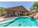 Inviting backyard pool with covered patio, slide, and seating area perfect for outdoor relaxation and entertainment at 3480 E Cullumber Ct, Gilbert, AZ 85234