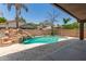 Backyard pool with rock waterfall feature and travertine pavers at 3480 E Cullumber Ct, Gilbert, AZ 85234