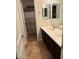Updated bathroom with double vanity, framed mirror, and updated flooring at 3480 E Sheffield Rd, Gilbert, AZ 85296