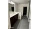 Bathroom with dark cabinetry, white countertops and neutral gray tile flooring at 3480 E Sheffield Rd, Gilbert, AZ 85296