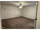 An empty bedroom that is carpeted with three windows at 3480 E Sheffield Rd, Gilbert, AZ 85296