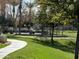 Manicured, open green space with walking path and park benches at 3480 E Sheffield Rd, Gilbert, AZ 85296