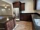 Modern kitchen featuring stainless steel appliances, dark cabinets, granite counters, and a center island at 3480 E Sheffield Rd, Gilbert, AZ 85296