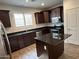 Modern kitchen featuring stainless steel appliances, dark cabinets, granite counters, and a center island at 3480 E Sheffield Rd, Gilbert, AZ 85296