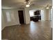 Open-concept living room with tile floors, ceiling fans, and an archway leading into a kitchen with dark wood cabinets at 3480 E Sheffield Rd, Gilbert, AZ 85296