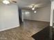 Open-concept living room featuring tile floors, ceiling fans, and an archway to the staircase at 3480 E Sheffield Rd, Gilbert, AZ 85296