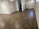 Spacious living room featuring tile floors that lead to the stairs and multiple doors at 3480 E Sheffield Rd, Gilbert, AZ 85296